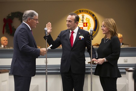 Director Selen (middle) is sworn in by Sen. Jon Bramnick as Selen’s wife, Tulin, holds the Quran.
