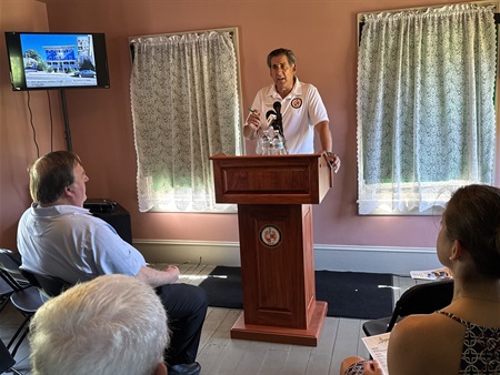 Deputy Commissioner Stephen Shaw address a crowd at the Ayres/Knuth farmhouse