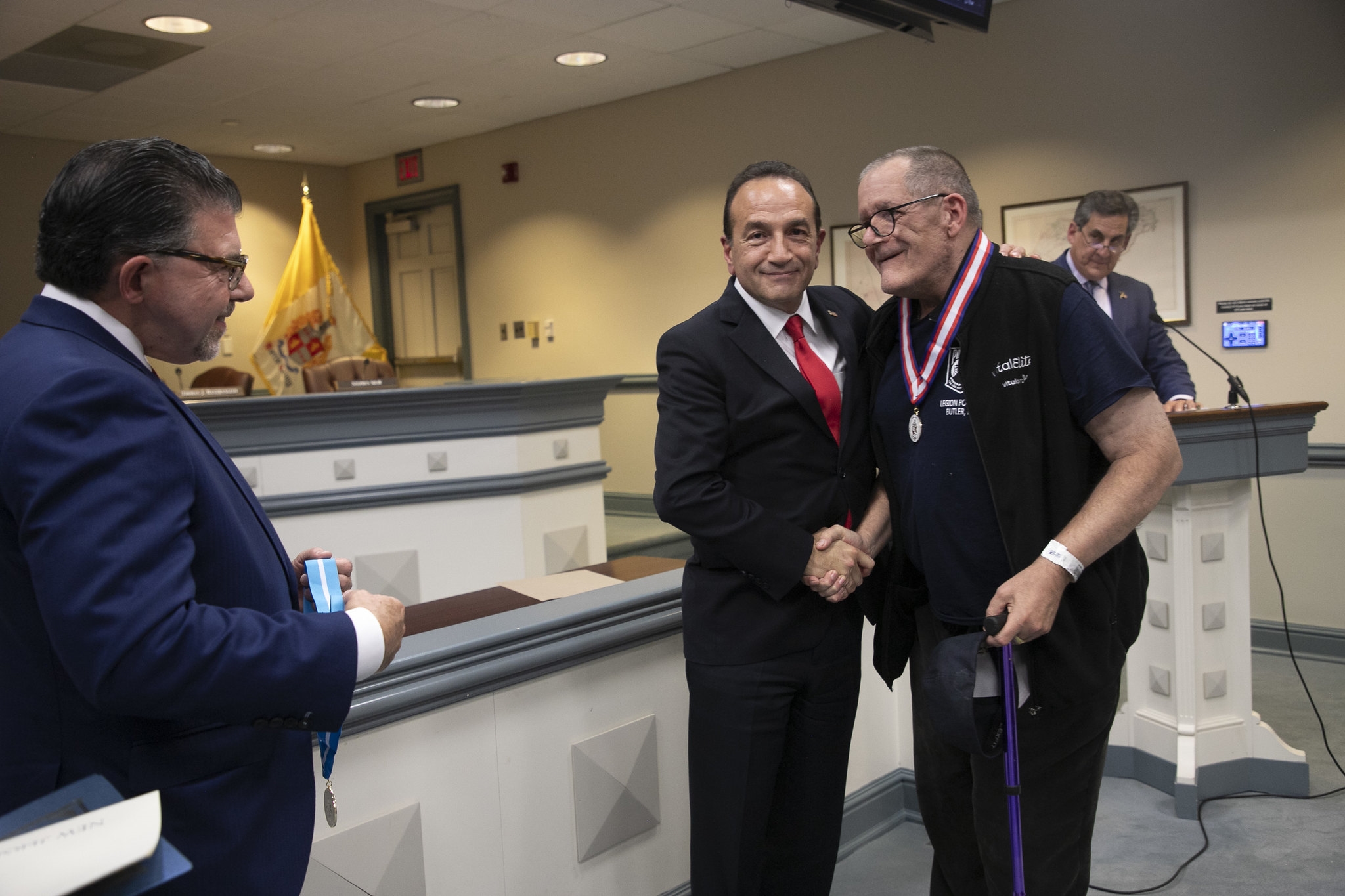 Sen. Anthony Bucco, Director Tayfun Selen and Jack B. Bosma. Deputy Director Stephen Shaw is at the podium.