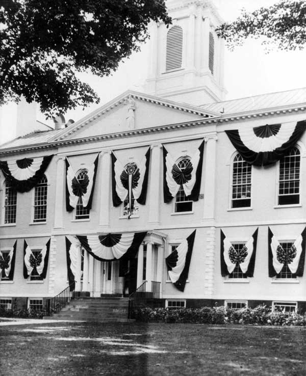 Courthouse in white, windows covered in bunting