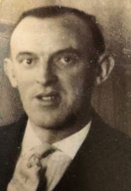 Hugh Parks Greer wearing a suit and tie