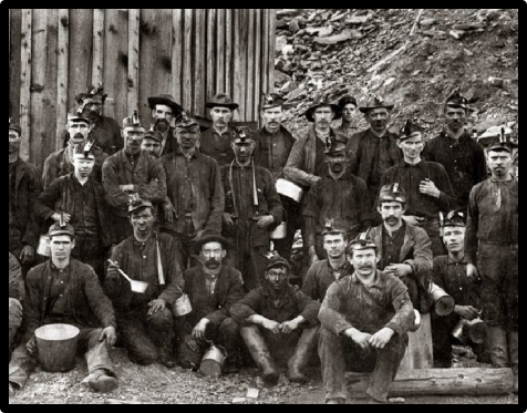 Group of miners in work clothes 