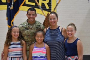 New Jersey Army National Guard Major Aaron Tomasini with his wife Jen and their three daughters at his pinning on August 14, 2020. 