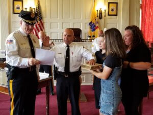 Morris County Sheriff James M. Gannon swears in Morris County Correctional Police Captain Joseph Michael Fucci to his new rank on September 14, 2020, while Captain Fucci's family holds the Bible.