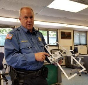 Morris County Sheriff's Office K-9 Section Detective John Granato with a Project Lifesaver tracking device.