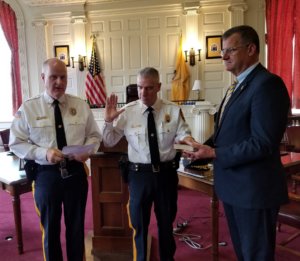 Morris County Sheriff James M. Gannon administers the oath of office as an Undersheriff to Richard A. Rose as Bureau of Law Enforcement Undersheriff Mark Spitzer holds a Bible. 
