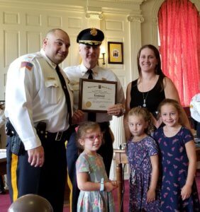 Newly-promoted Morris County Correctional Police Lieutenant Timothy Stewart at his swearing-in, with his family and Morris County Sheriff James M. Gannon holding the plaque. 