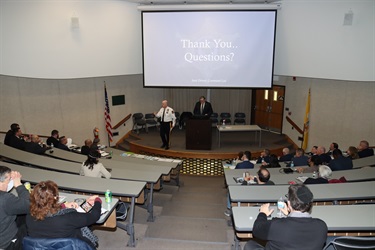 Sheriff Gannon and Prosecutor Carroll speak on the stage