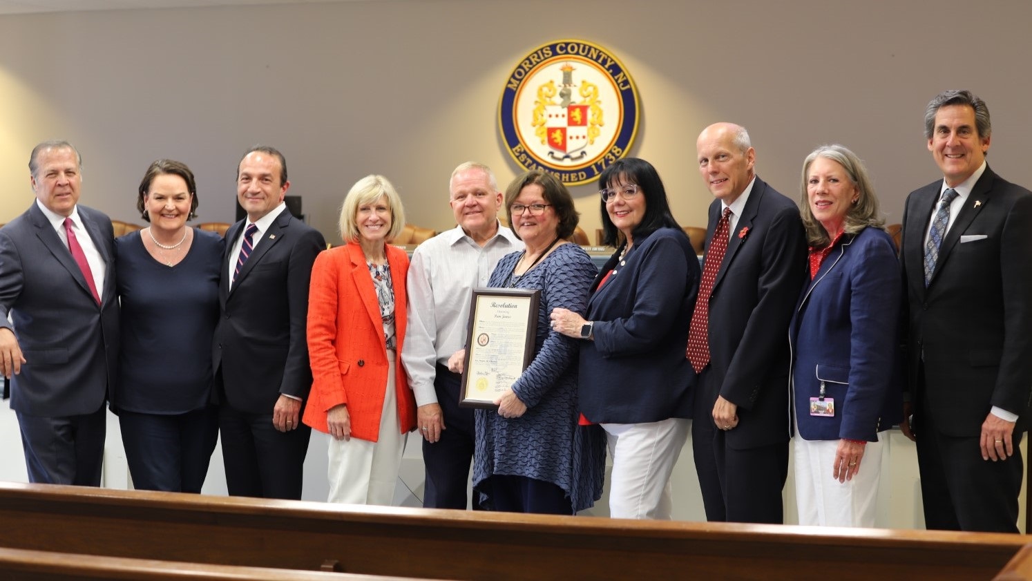 (Photo: (L-R) Commissioner Tom Mastrangelo, Deputy County Clerk Anna McMahon, Commissioner Tayfun Selen, Deputy Director Christine Myers, Commissioner Doug Cabana, Pam James, County Clerk Ann Grossi, Director John Krickus, Commissioners Deborah Smith and Stephen Shaw. Credit | Morris County)
