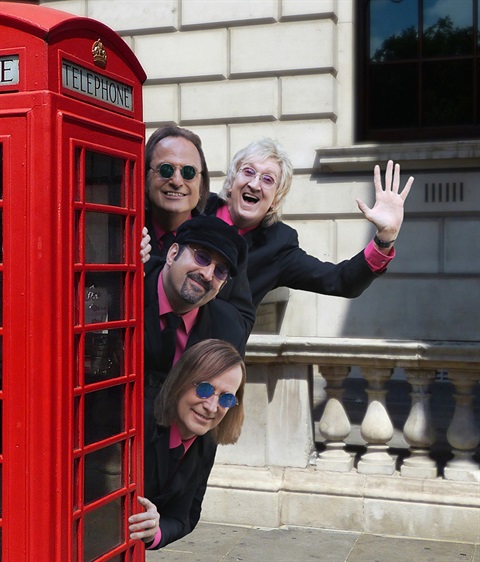 British Invasion Years musical group members with a red British phone booth