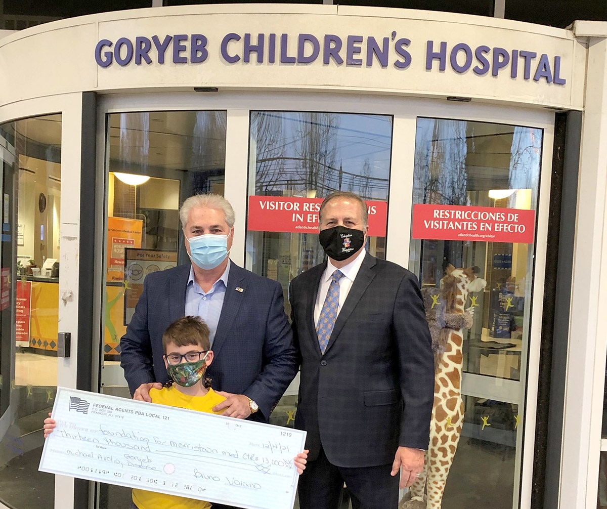 (Photo: Commissioner Mastrangelo (right) with Local 121 President Bruno Varano (L) and (holding the check) Michael Avolio, a patient at Goryeb Children’s Hospital.