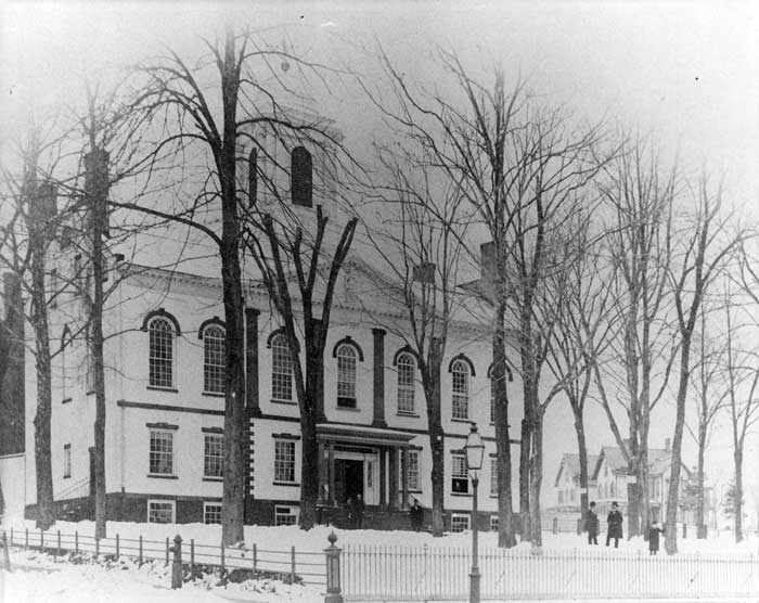 The courthouse in 1860, surrounded by trees and the roof covered in snow