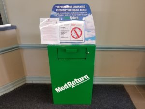 Green drug drop box with a deposit drawer