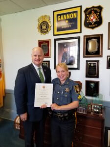 Sheriff gannon presenting Cpl. Valvano the certificate in his office