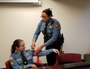 Morris County Sheriff's Office Investigator Balkis Bernard demonstrates on Sheriff's Office Corporal Jen Parrillo how to properly secure a tourniquet to control bleeding.