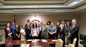 Morris County Sheriff James M. Gannon and Morris County Sheriff's Officer Stephanie Mitchell join the freeholders and leaders of JBWS at a freeholder meeting where a proclamation thanking the non-profit for all its work was given in recognition of October as Domestic Violence Awareness month.