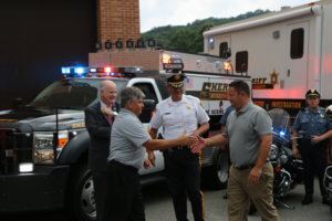 Morris County Sheriff James M. Gannon and Bureau of Law Enforcement Undersheriff Mark Spitzer look on as Sheriff's Office Chief Edward Crooker and Sheriff's Office Detective Captain Bruce Dunn wish each other happy retirements on July 31, 2019, after 25 years of service.