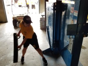 A 2019 Morris County Public Safety Youth Academy Cadet practices breaching a door with a steel ram.