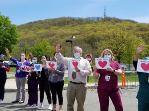 Health Care Workers at St. Clare's Hospital-Dover respond to a motorcade in their honor on May 5, 2020. 