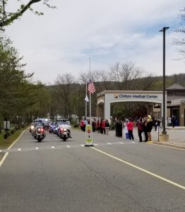 A police motorcade in honor of health care workers proceeds past Chilton Medical Center in Pequannock on May 5, 2020. 