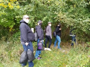 Al Shurdom of the Mental Health Association of Essex and Morris, Morris County Sheriff's Officer Chelsea Whiting, Antonella McGee of the Morris County Office of Temporary Assistance and Morris County Sheriff's Office Corporal Erica Valvano enter woods on Sept. 29 as part of a Hope One homeless community outreach initiative. 
