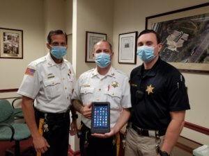 From left, Morris County Sheriff's Office Corrections Lieutenant Michael Schweizer, Corrections Sergeant Raymond Dykstra and Corrections Sergeant Shawn Johnston with a tablet, one of more than 75 that Morris County Correctional Facility inmates will be able to access to have virtual visits with relatives and friends.