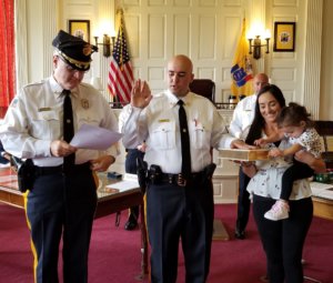 With his wife and one of his two children beside him, newly-promoted Morris County Correctional Police Sergeant Nicolas Monaco is sworn in to his new position on September 14, 2020, by Morris County Sheriff James M. Gannon.