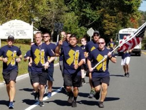 Officers from the Morris County Sheriff's Office Bureau of Corrections carry the American flag and torch during Friday's Law Enforcement Torch Run to benefit Special Olympics NJ