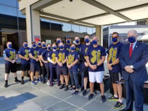 Morris County Sheriff James M. Gannon, right corner, stands with Sheriff's Office Bureau of Corrections Officers as they wait to receive the torch and run a stretch of the Law Enforcement Torch Run to benefit Special Olympics NJ on Oct. 9, 2020. 