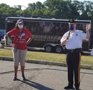 Morris County Sheriff James M. Gannon, joined by Teresa Williams, greets volunteers at the Table of Hope Mobile Food Pantry distribution at County College of Morris on June 23. 