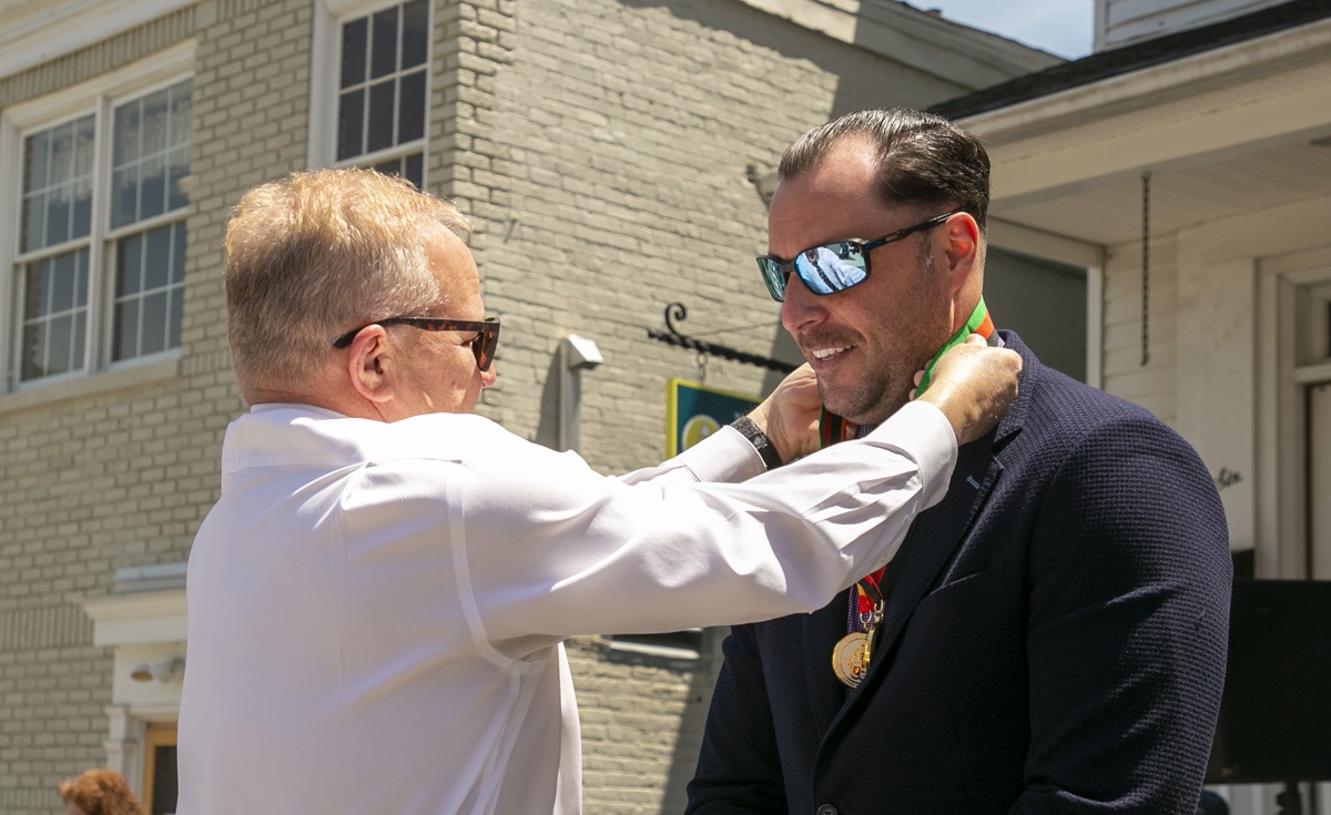 Commissioner Cabana presents a medal to Barbato