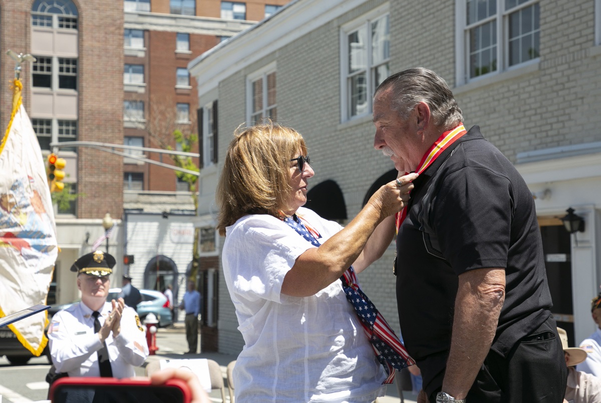 Commissioner DeFillippo presents Schumm with a medal