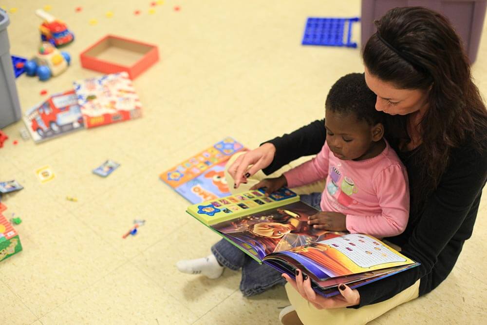 Family Promise member reading to a small child