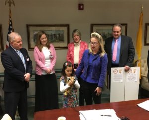 (l/r) Freeholder Doug Cabana, Katherine Coyle, Stella Coyle, Freeholder Deborah Smith, teacher Kimberly McCurnin, and John Coyle