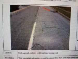 photo shows cracks in bridge road surface