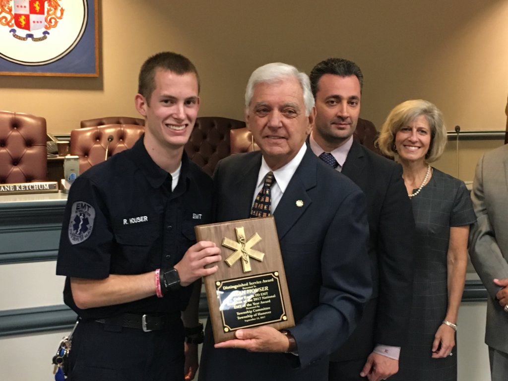 photo of Hanover Mayor Ron Francioli presents a plaque to Ryan Houser as Freeholders John Cesaro and Christine Myers look on