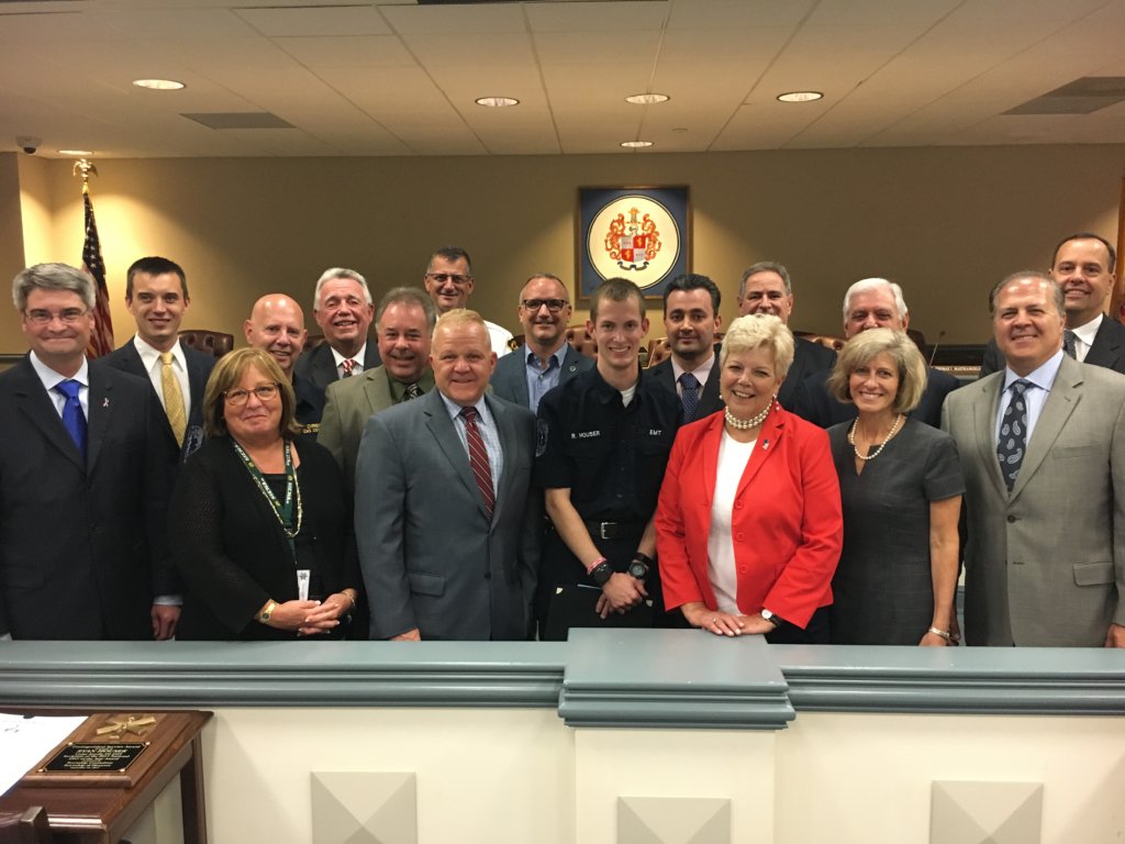 Ryan Houser (center) honored at Morris County Freeholder Board meeting in Morristown. Photo shows him surrounded by some two dozen officials.