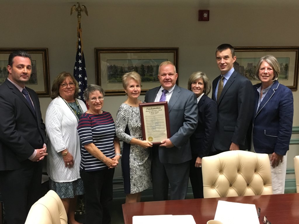 photo of plaque presentation: (l/r) Freeholders John Cesaro and Kathy DeFillippo, Vision Loss Alliance of NJ client Ursula Rucki and Executive Director Kris Marino, and Freeholders Doug Cabana, Christine Myers and Hank Lyon 