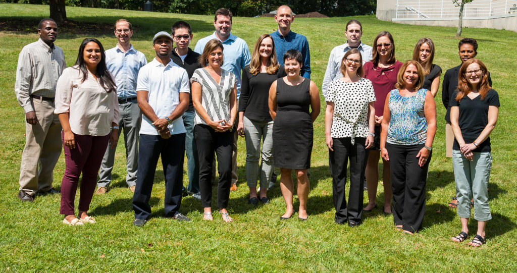 photo of all 18 CCM faculty standing in a field together