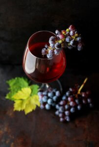 Full wine glass and grapes