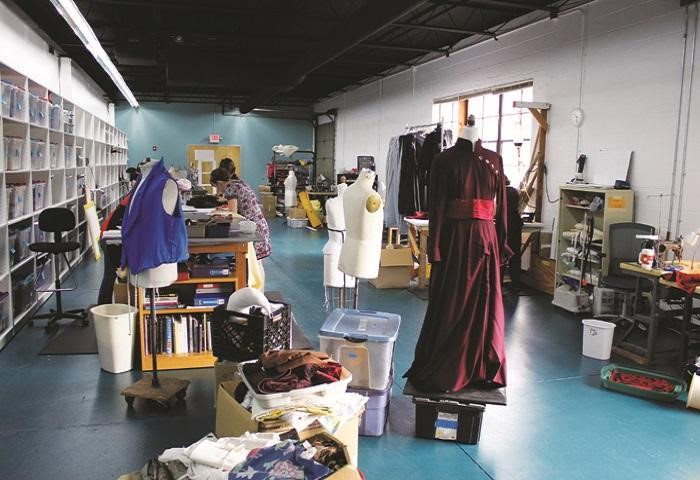 Costume design studio with a long red dress displayed