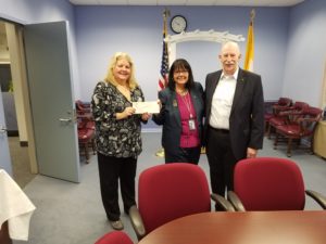 photo of (l/r) Family Promise Executive Director Joann Bjornson, Councty Clerk Grossi, and Family Promise Board President Stephen Hammond