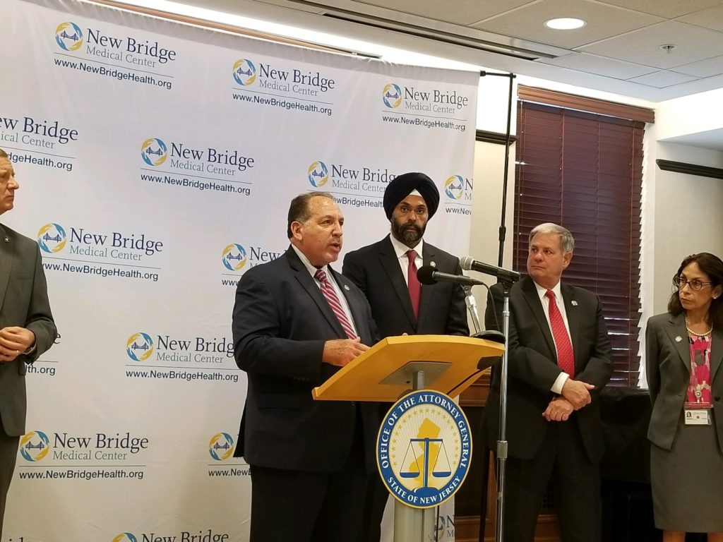 photo of Prosecutor Knapp speaks at the Operation helping Hand kickoff as State Attorney General Gurbir Grewal looks on