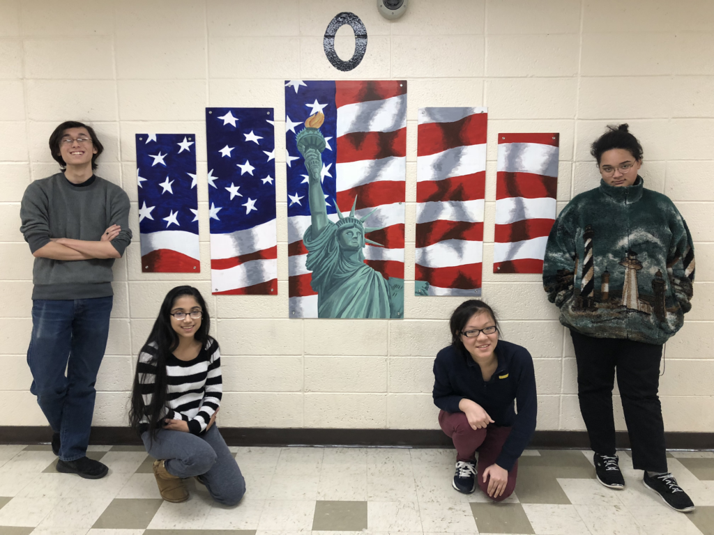 photo of (l/r) James Sullivan, Michelle Lad, Rebecca Weng, and Hannah Rohn at Roxbury High School with the flag mural