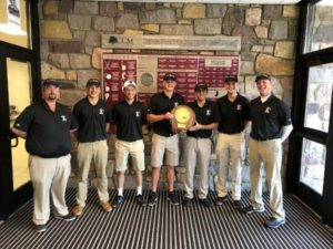 Golf team's 5 members pose with 2 coaches and their trophy at the school.