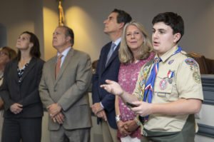 Kinnelon Eagle Scout Jason Meenan talks about his Eagle Scout project as the Morris County Freeholders look at photos of his presentation on a screen.