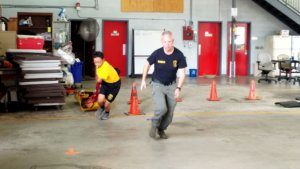 Morris County Office of Emergency Management Director Jeffrey Paul works with a 2019 Morris County Public Safety Youth Academy Cadet on navigating an obstacle course designed to promote speed, agility, clarity of mind and strength in emergency situations.