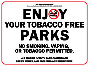 Sign that reads: Enjoy your tobacco free parks. No smoking, vaping or tobacco permitted. All Morris County Park Commission parks, trails and facilities are smoke free.