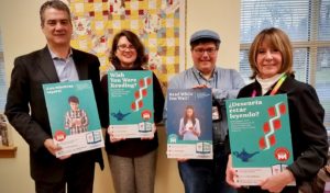Library officials hold up Pop-Up Library posters