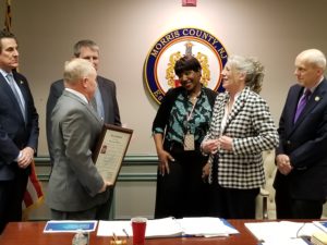Charmayne Bowie jokes with Freeholder Doug Cabana, as other officials look on